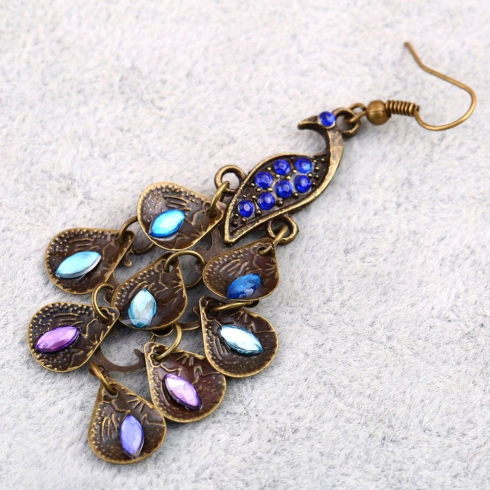 multi colored peacock earrings hanging blue pink